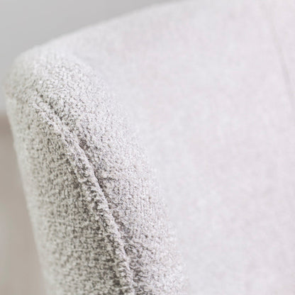 Irene – poltrona in tessuto bouclé con struttura a molle